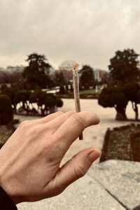 Tourists smoking a marijuana spliff at Retiro Park Madrid